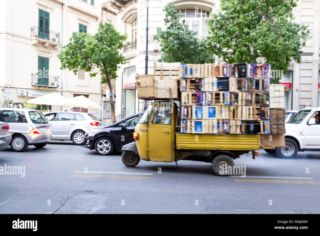 Three-wheeled vehicle loaded with fruit crates. Palermo, Sicily. Italy Stock Photo