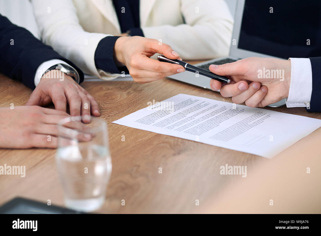 Business woman giving pen to businessman ready to sign contract ...