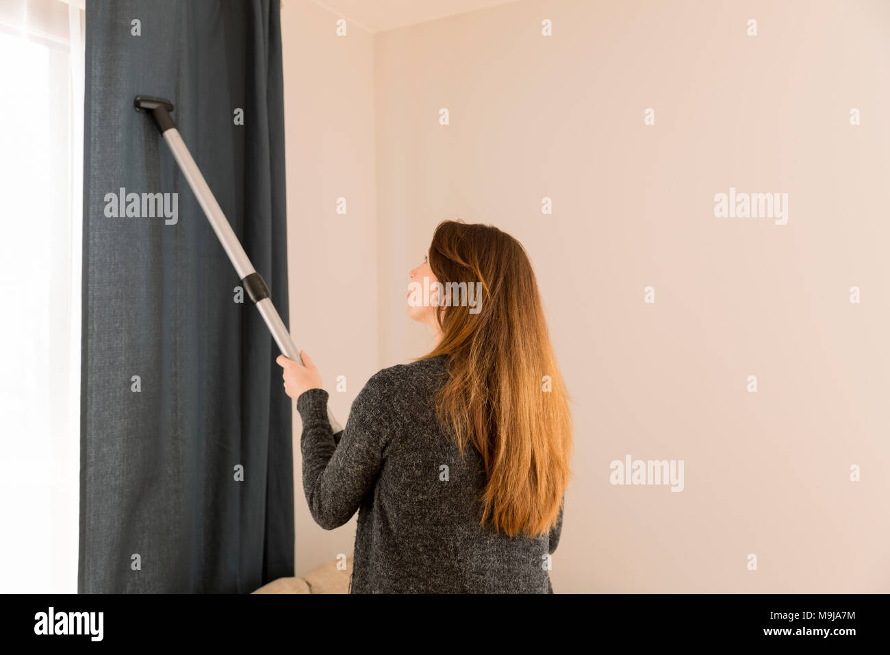 People, housework and housekeeping concept woman with vacuum cleaner