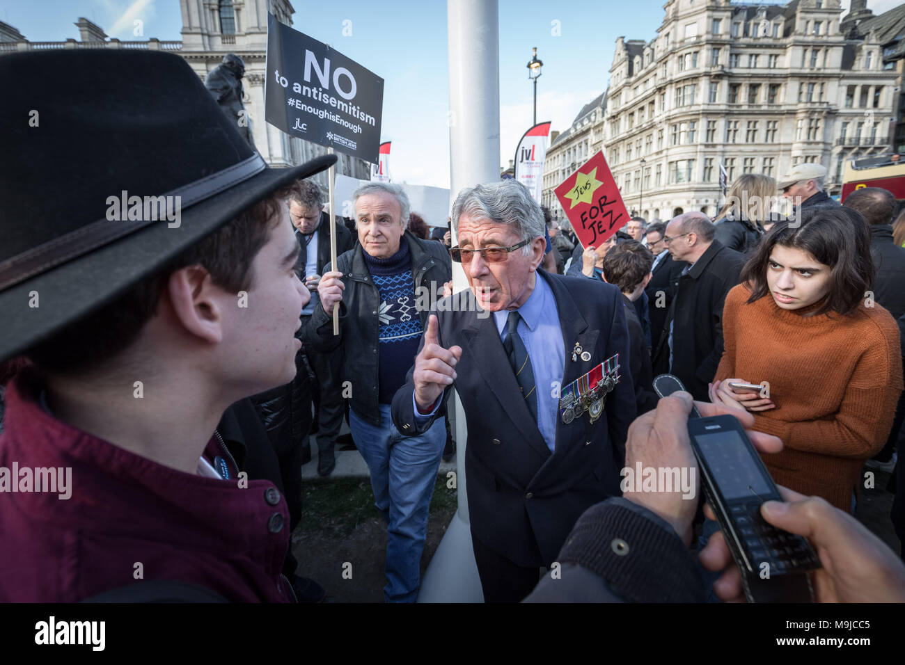 London, UK. 26th March, 2018. A Jewish former member of the armed forces and Labour supporter debates with an outspoken Zionist activist (L) during the protest. Hundreds of protesters, including members of the Jewish community, demonstrate against antisemitism in Parliament Square. Labour leader Jeremy Corbyn has conceded that there is a problem with antisemitism within the Labour party that the party has still yet to resolve. Credit: Guy Corbishley/Alamy Live News Stock Photo