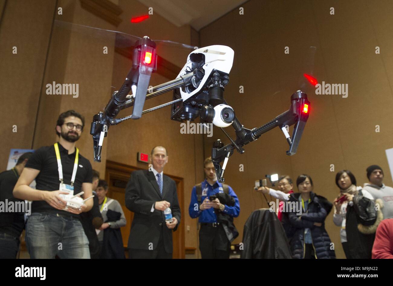 Beijing, USA. 4th Jan, 2015. Representatives from Chinese DJI company show Inspire 1 quadcopter during the preview media show of The Consumer Electronics Show (CES) in Las Vegas, the United States, Jan. 4, 2015. A 'huge' trade deficit with China is reportedly behind the U.S. administration's plan to slap tariffs on up to 60 billion U.S. dollars of Chinese imports and restrict Chinese investment. But data sometimes lies, and could shield the bigger picture. Credit: Yang Lei/Xinhua/Alamy Live News Stock Photo