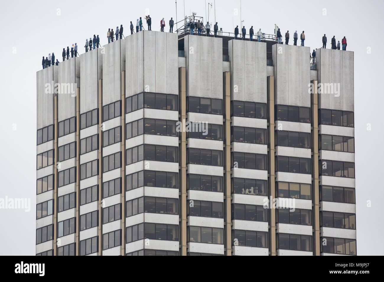 London, UK. 27th March, 2018. 84 life-sized sculptures by Mark Jenkins have been positioned on the top of the ITV Television Centre building as part of Project 84 by the charity CALM (Campaign Against Living Miserably) to represent the 84 men who take their own lives in the UK every week and so to raise awareness of male suicide. Male suicide is the single biggest killer of men under the age of 45 in the UK. Credit: Mark Kerrison/Alamy Live News Stock Photo