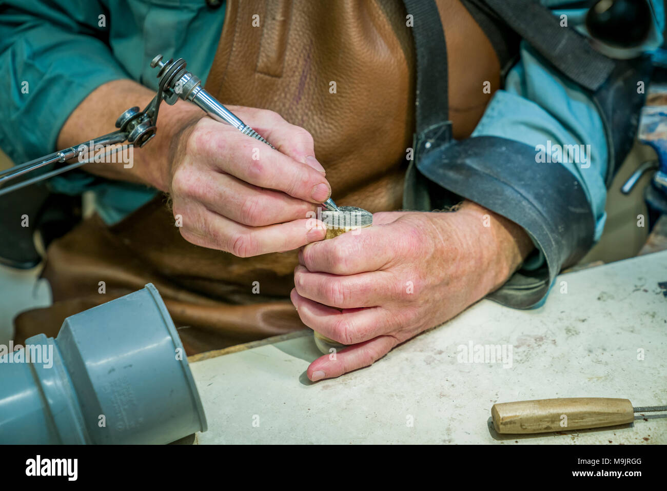 Bladesmith or knifemaker working in his shop, Iceland Stock Photo