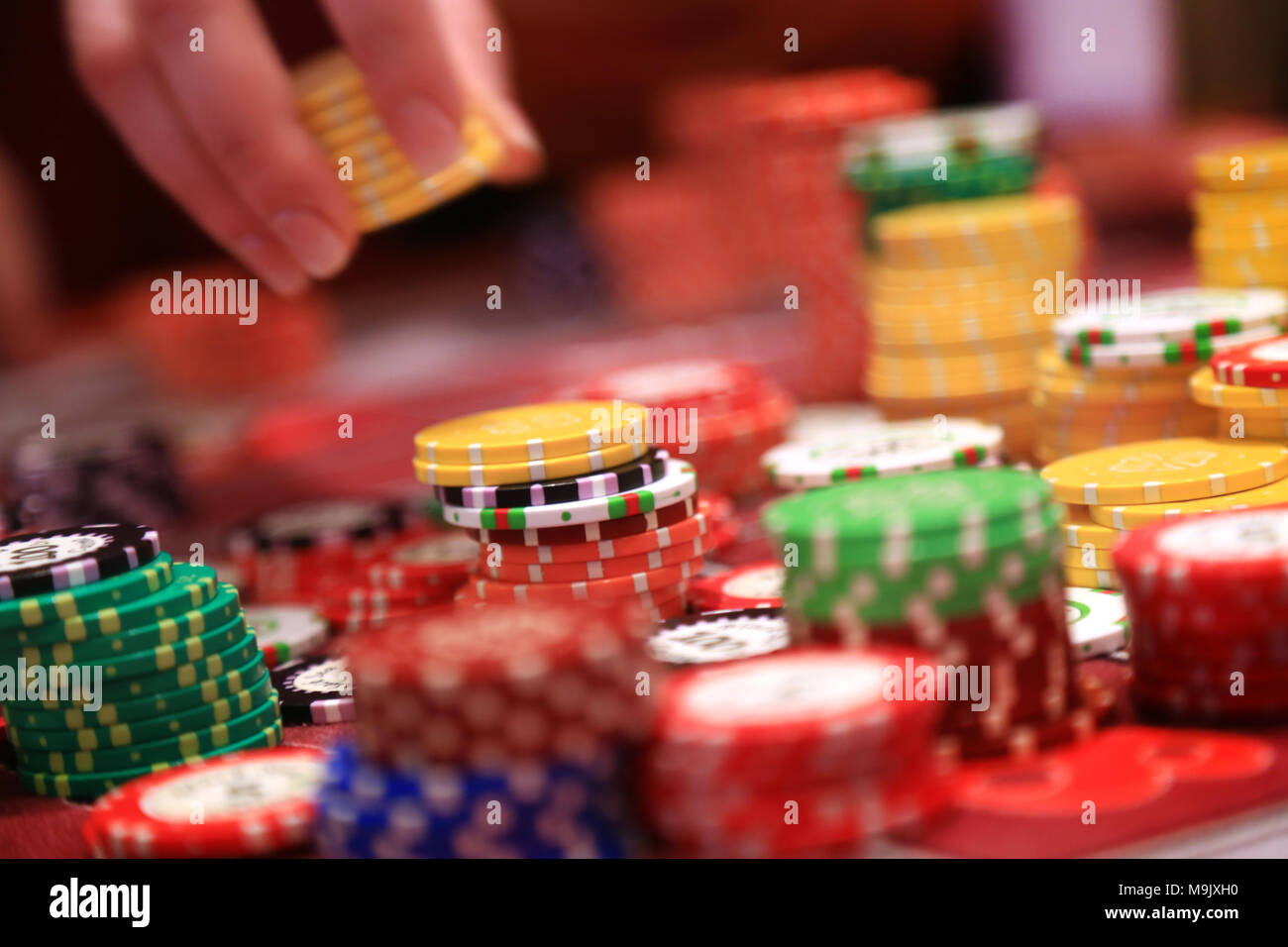 Player placing chips on a gambling table in casino Stock Photo