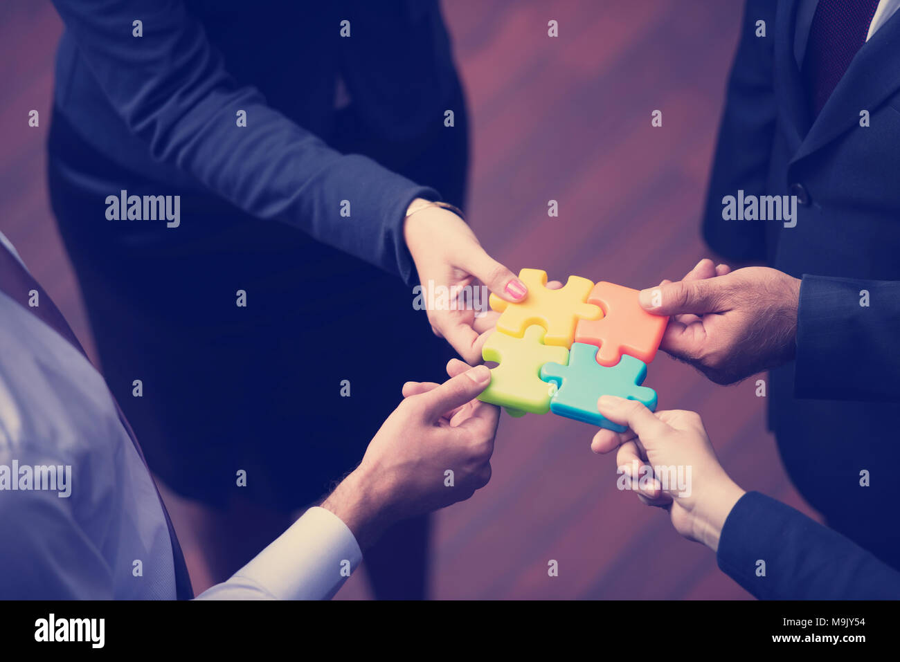diverse business people group assembling jigsaw puzzle and represent team  support and help concept, top view perspective at modern bright office inter  Stock Photo - Alamy
