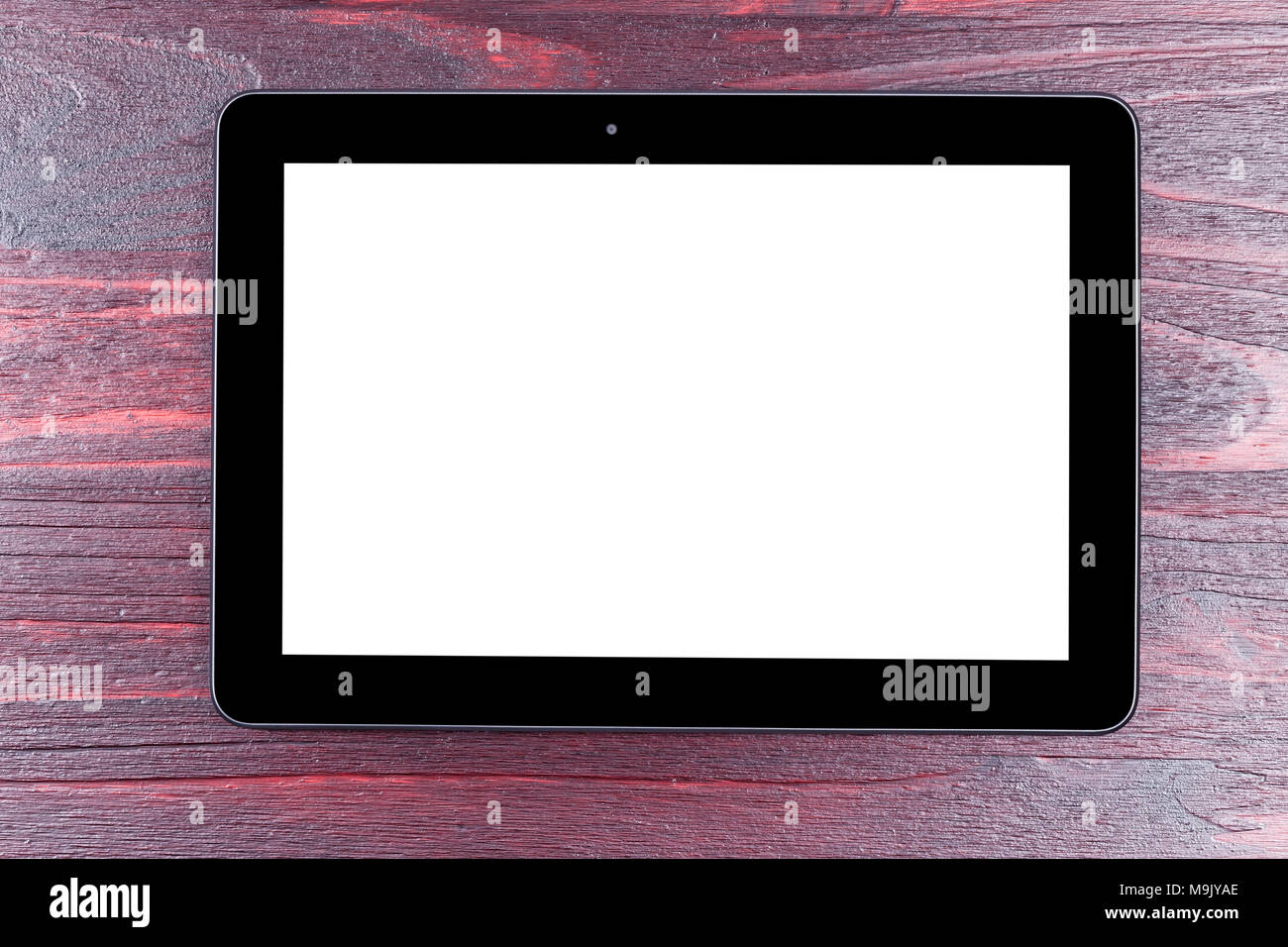 Black tablet template with white screen isolated on mahogany wood. Stock Photo