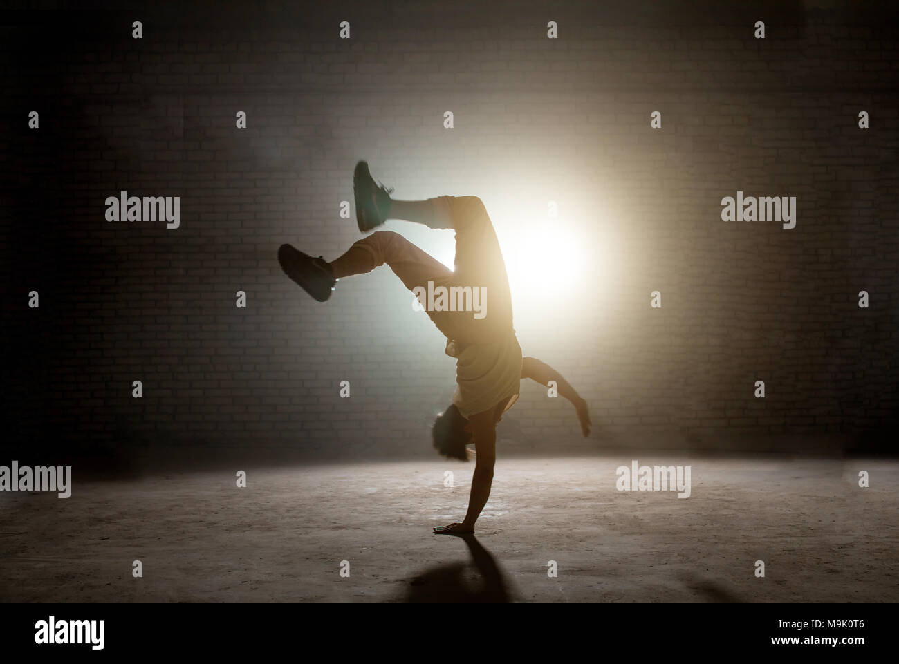 b-boy is dancing break dance and doing downrock. strong teen.dancing skills Stock Photo