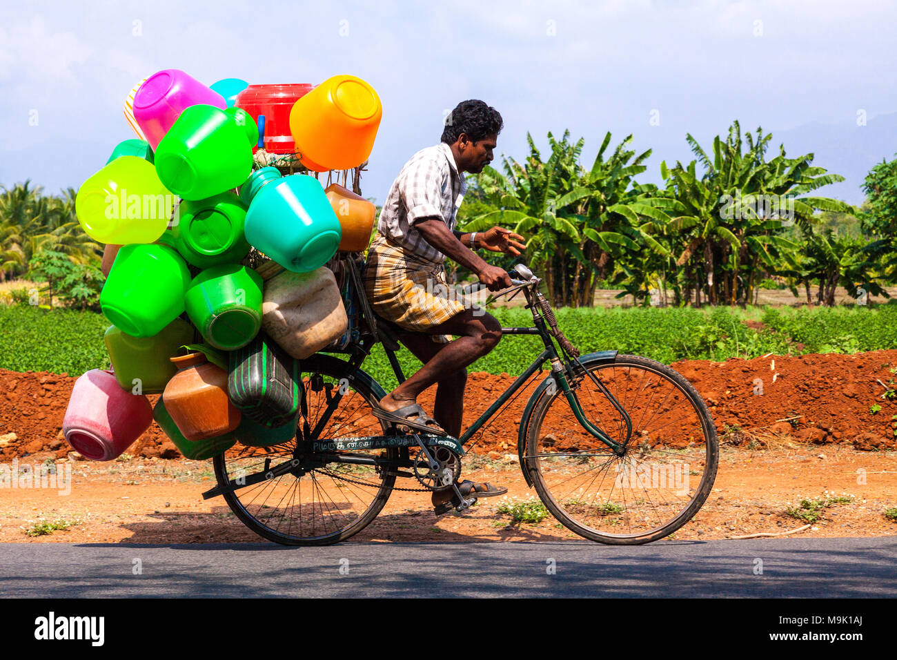 Salesman on bicycle, selling plastic buckets - Tamil Nadu, India. Stock Photo