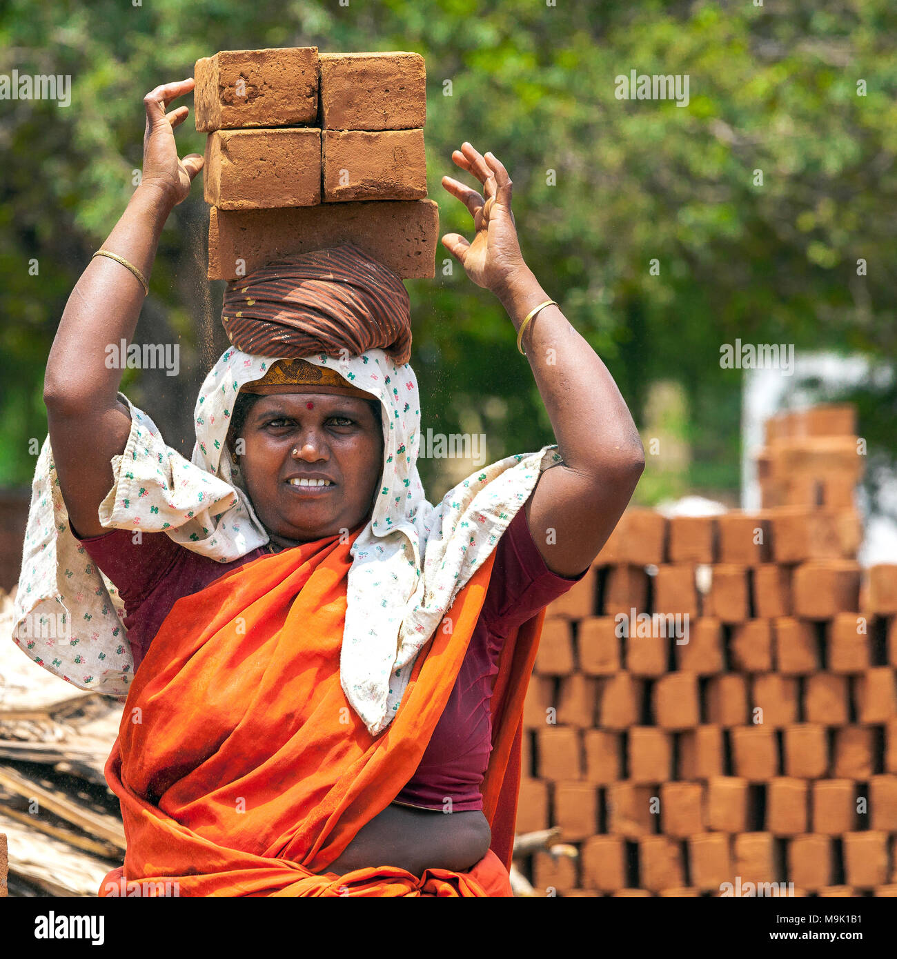 Women are employed in the heavy work of brick making industry in