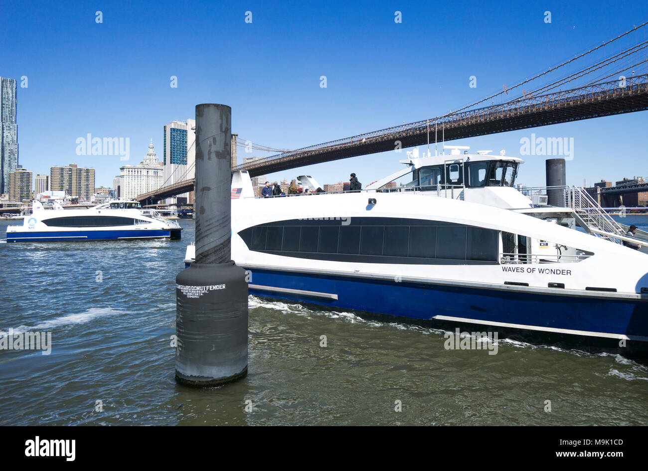 NYC Ferry docking at the Dumbo pier with the Brooklyn Bridge above