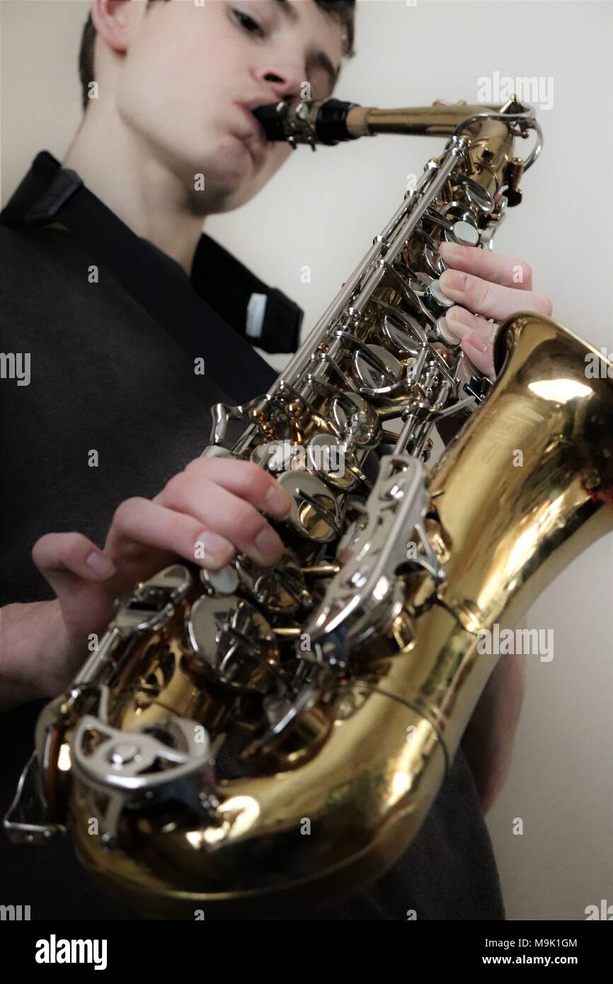 Teenager playing the saxophone Stock Photo Alamy