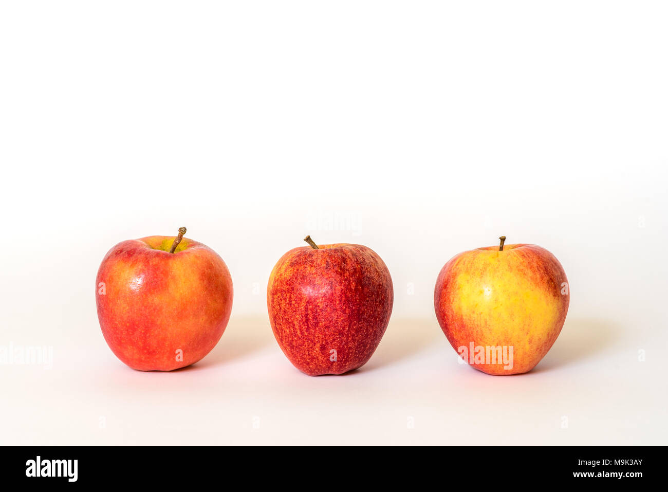 Three fresh red apples isolated on a white background Stock Photo