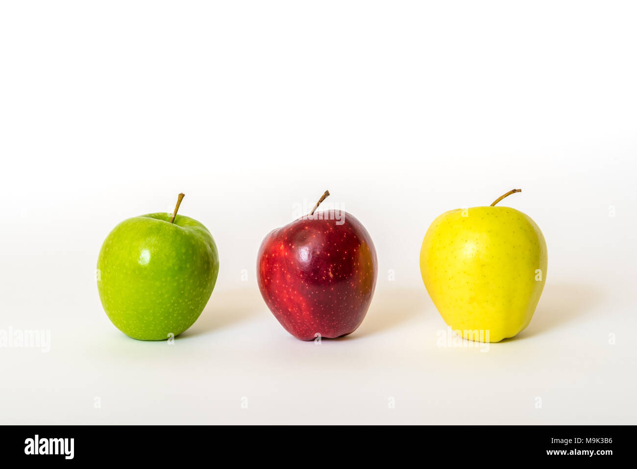Three different coloured fresh apples isolated on white background Stock Photo