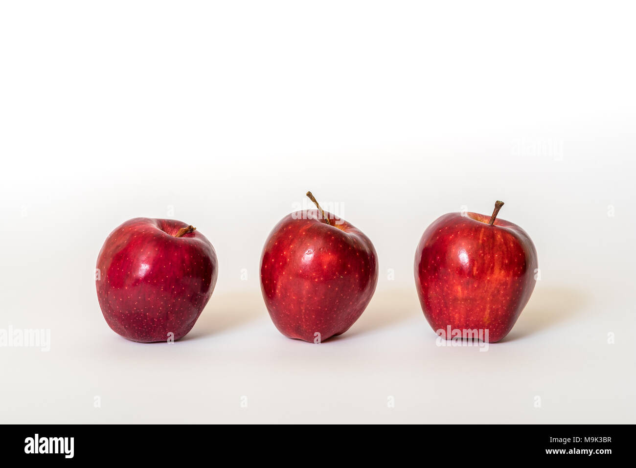 Three fresh red apples isolated on a white background Stock Photo