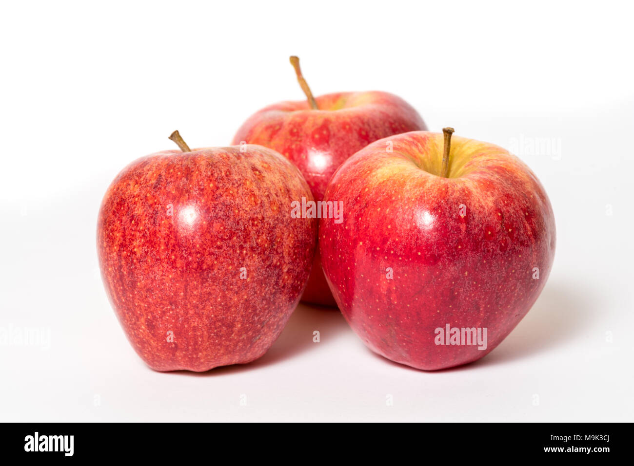 Three fresh red apples isolated on a white background Stock Photo