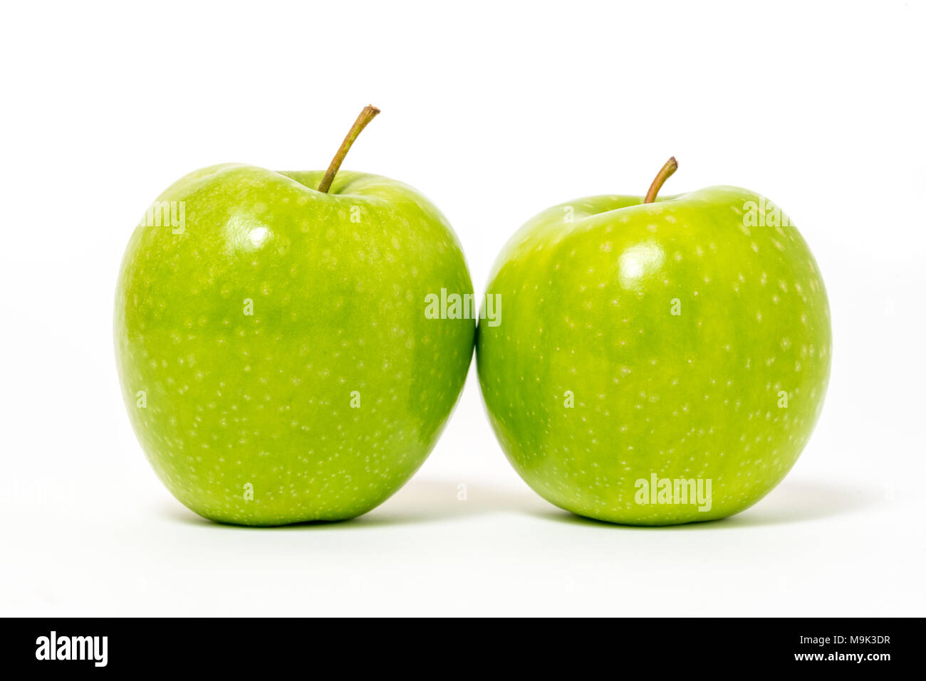 Two fresh green apples isolated on white background Stock Photo