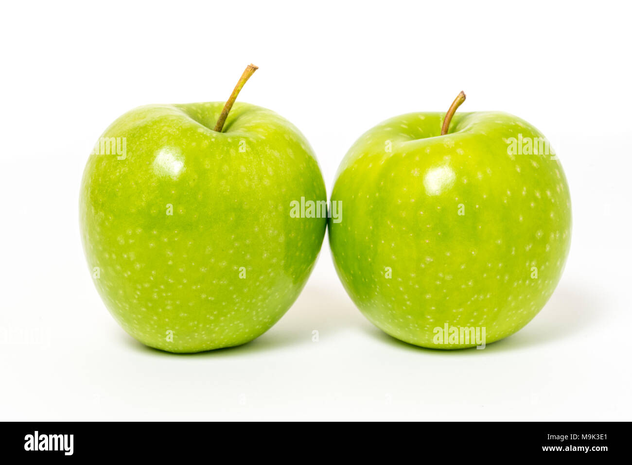 Two fresh green apples isolated on white background Stock Photo