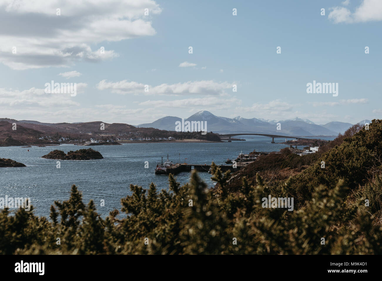 View of Skye Bridge and a small coastal village on Isle of Skye ...