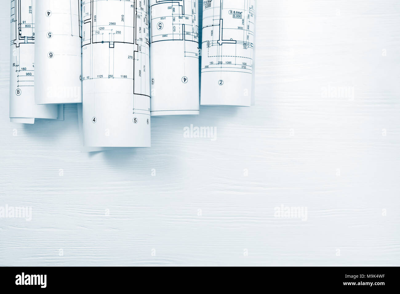 architectural blueprints and blueprint rolls on white wooden desk Stock ...