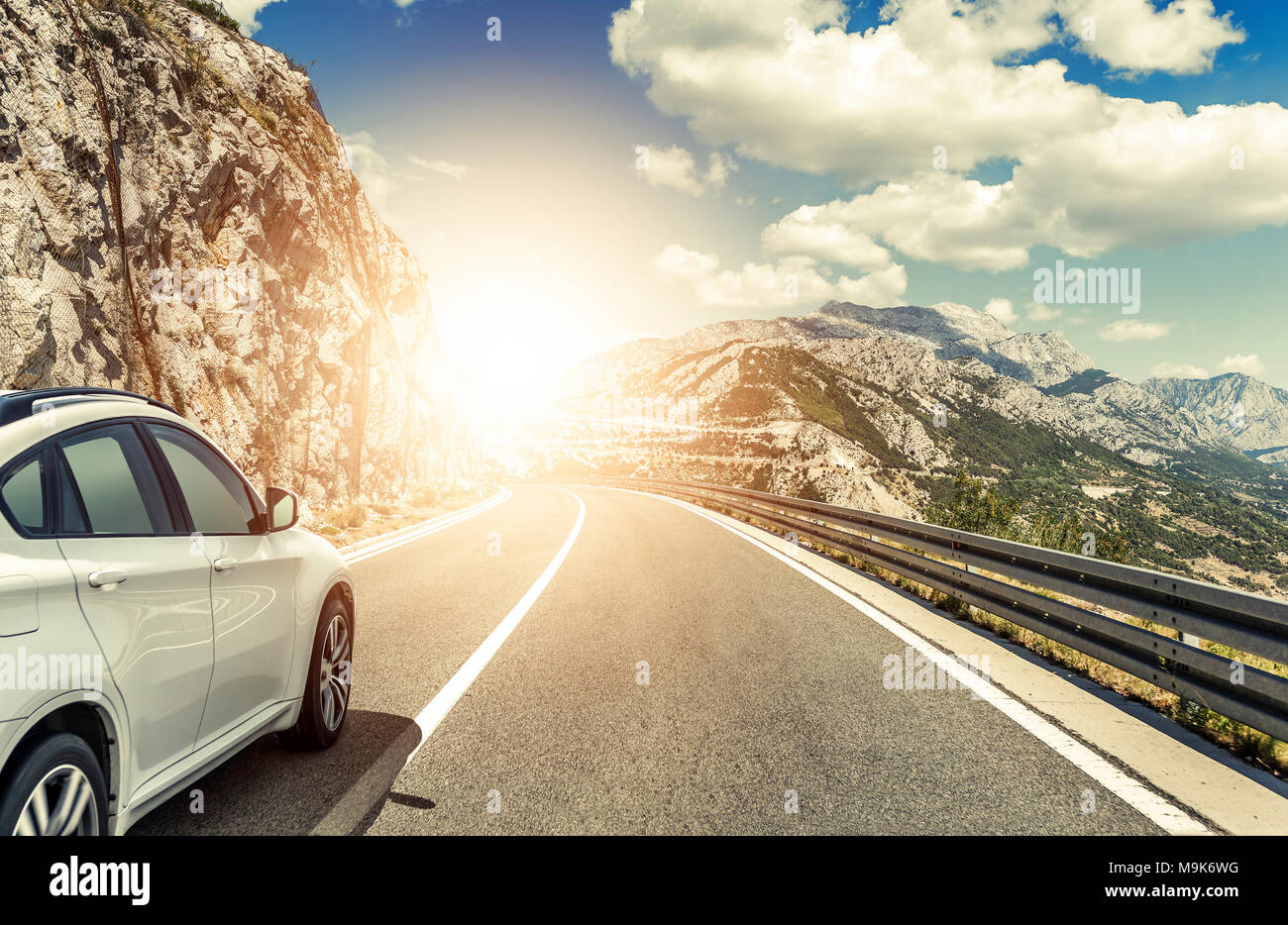 A white car rushing along a high-speed highway in the sun Stock Photo ...