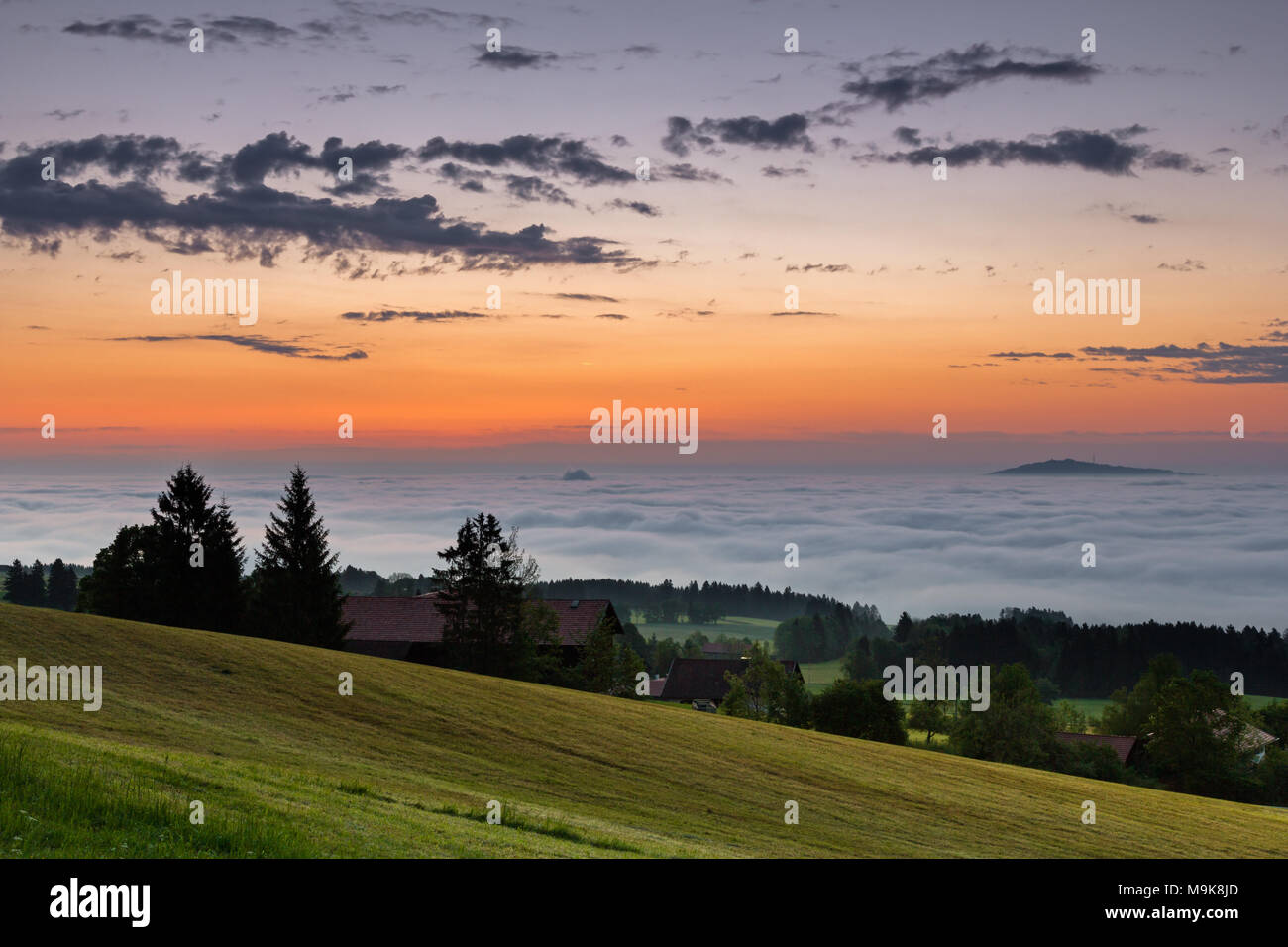 Sunrise on Auerberg mountain above the foggy Lech valley, Bavaria, Germany Stock Photo