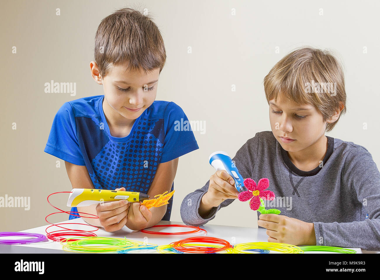 Happy children creating with 3d printing pen Stock Photo - Alamy
