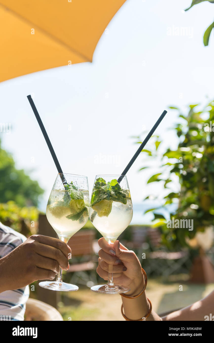 Hand holding cocktail umbrella hi-res stock photography and images - Alamy