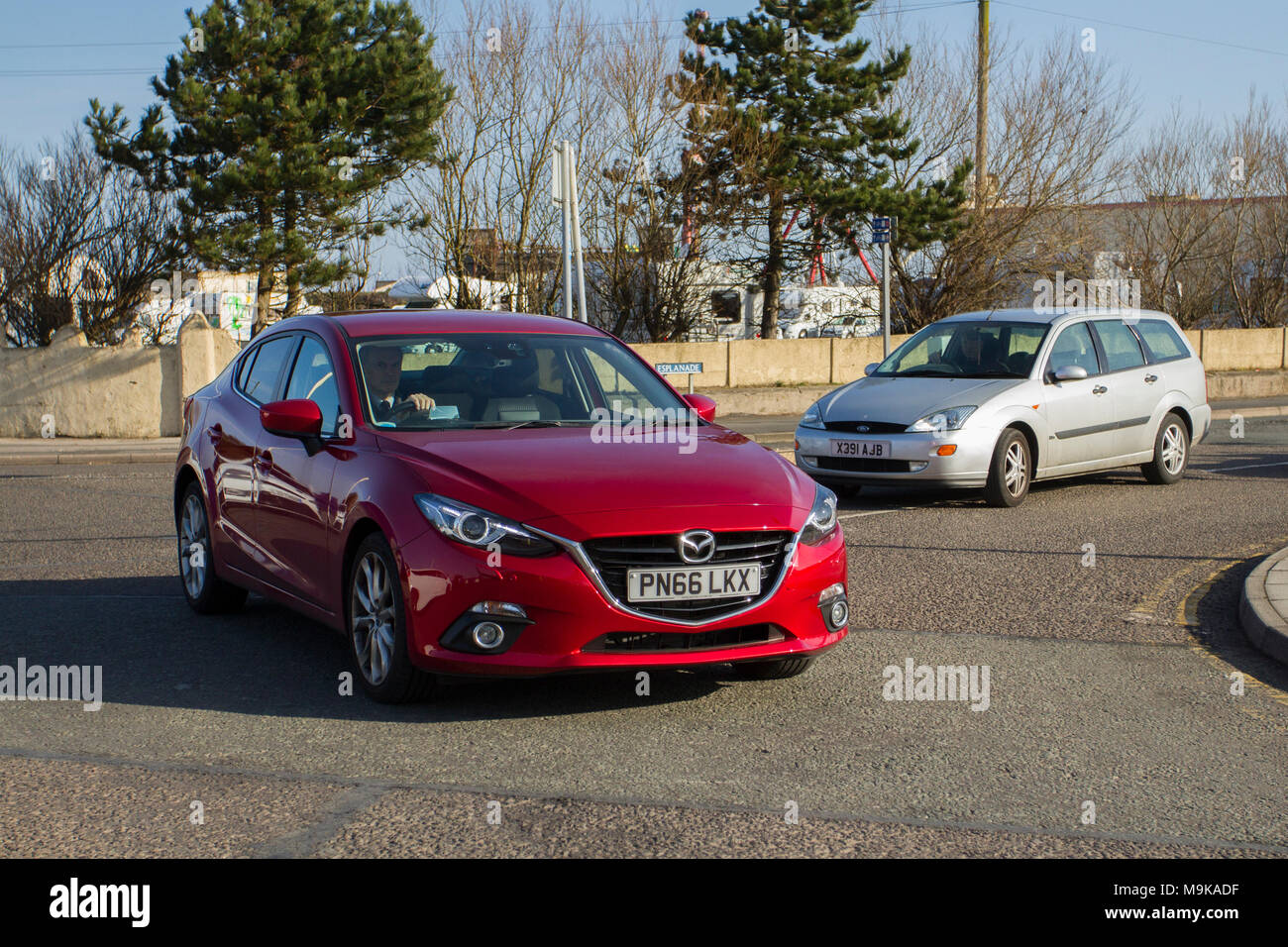 2012 red Mazda 3 Sport D at North-West Supercar event as cars and tourists arrive in the coastal resort on a warm spring day. Stock Photo