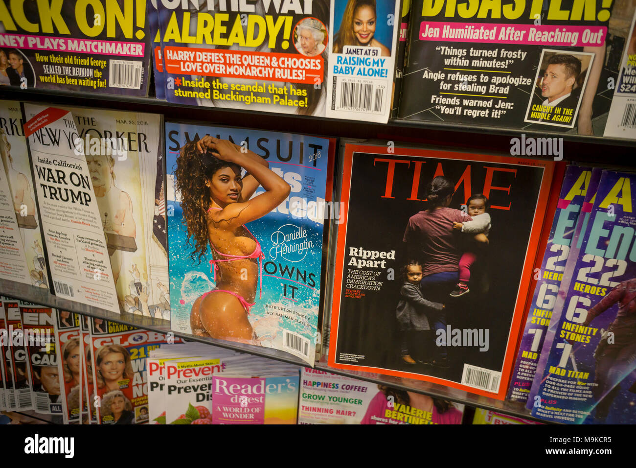 Time and sports Illustrated magazines are seen along with other periodicals on a newsstand in New York on Thursday, March 22, 2018. Meredith Corp., which purchased Time Inc. announced it is considering selling the non-lifestyle brands it picked up in the acquisition, including the flagship Time, Sports Illustrated, Money and Fortune. Meredith acquired Time in January 2018. (Â© Richard B. Levine) Stock Photo