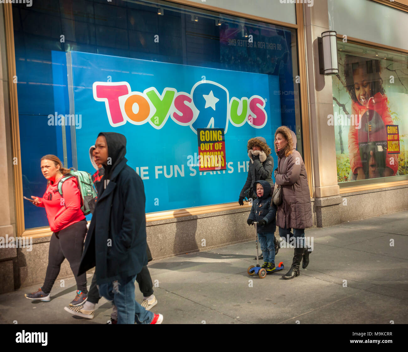 Signs posted on the window of the Toys R Us store in Times Square in New York on Friday,  March 23, 2018 announce that the store is closing and liquidation has begun. Toys R Us is liquidating and closing all 735 of its U.S. stores. The CEO of MGA Entertainment, Issac Larian, the maker of the Bratz dolls, announced a pledge of $200 million, and the creation of a GoFundMe campaign, to save approximately 400 of the 735 closing stores. (© Richard B. Levine) Stock Photo