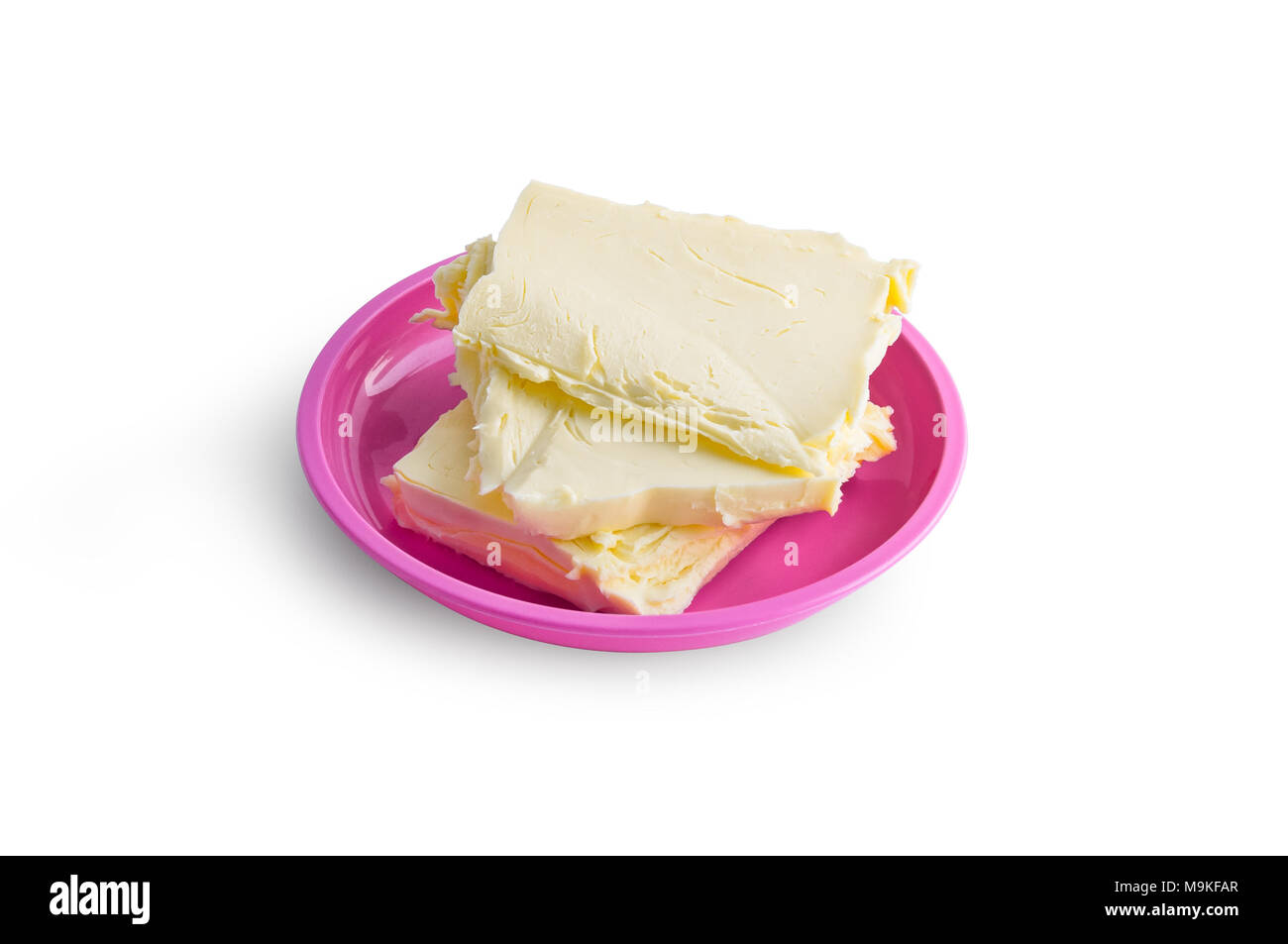 Butter on the plate. Pieces are weighed according to a recipe and prepared for making a cream for a cake or dough Stock Photo