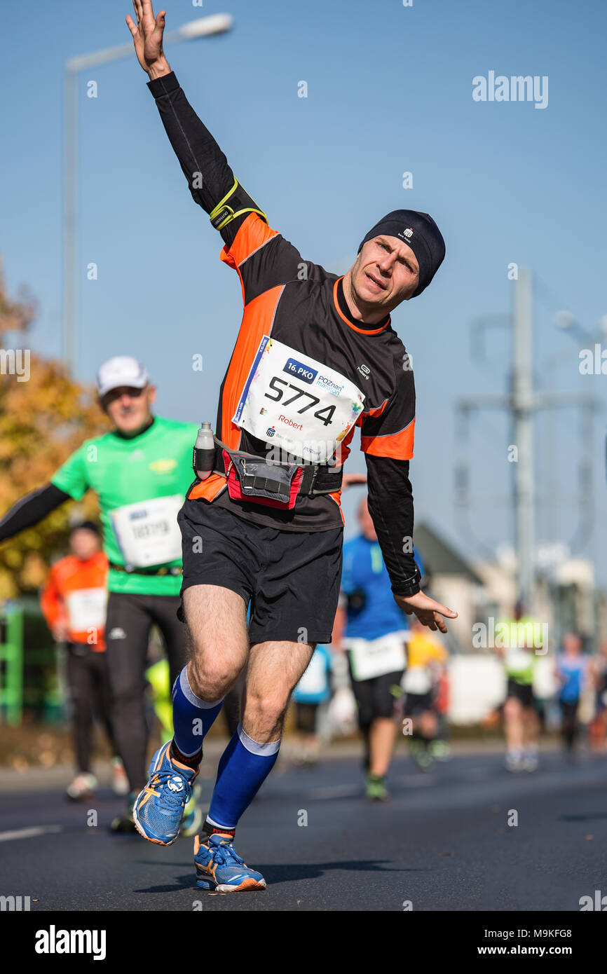 Marathon in Poznan, Poland. Colorful people, pop culture characters, 16.  PKO Poznan Maraton.Filled with joy, happy people running on the sunny  streets. Autumn leaves and colours. (16. PKO Poznan Maraton Stock Photo -