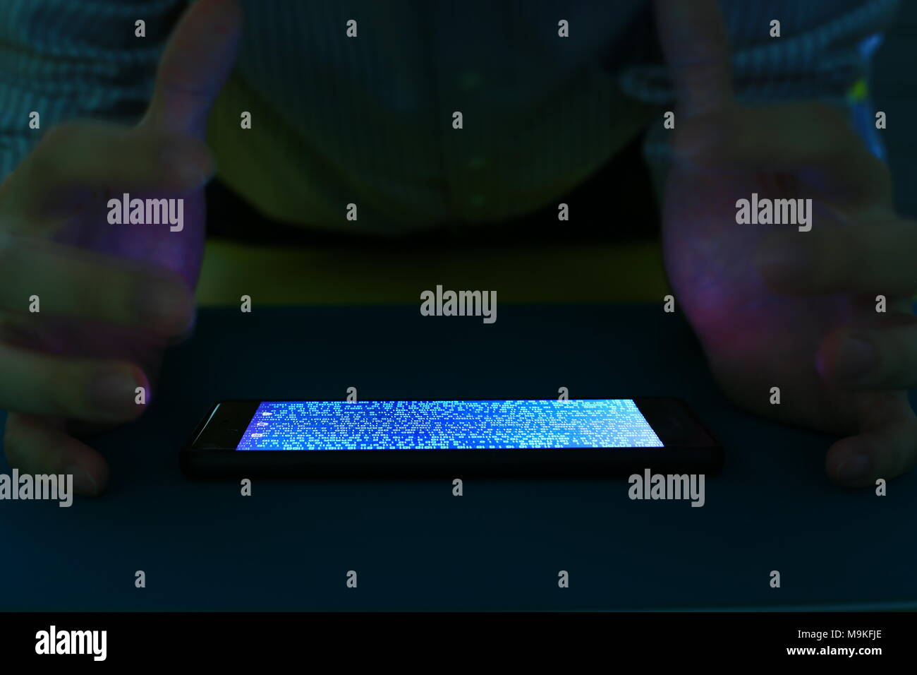 smartphone with code binary on screen. man trying to get pass lock screen. phone error and phone addiction problem concept. Stock Photo