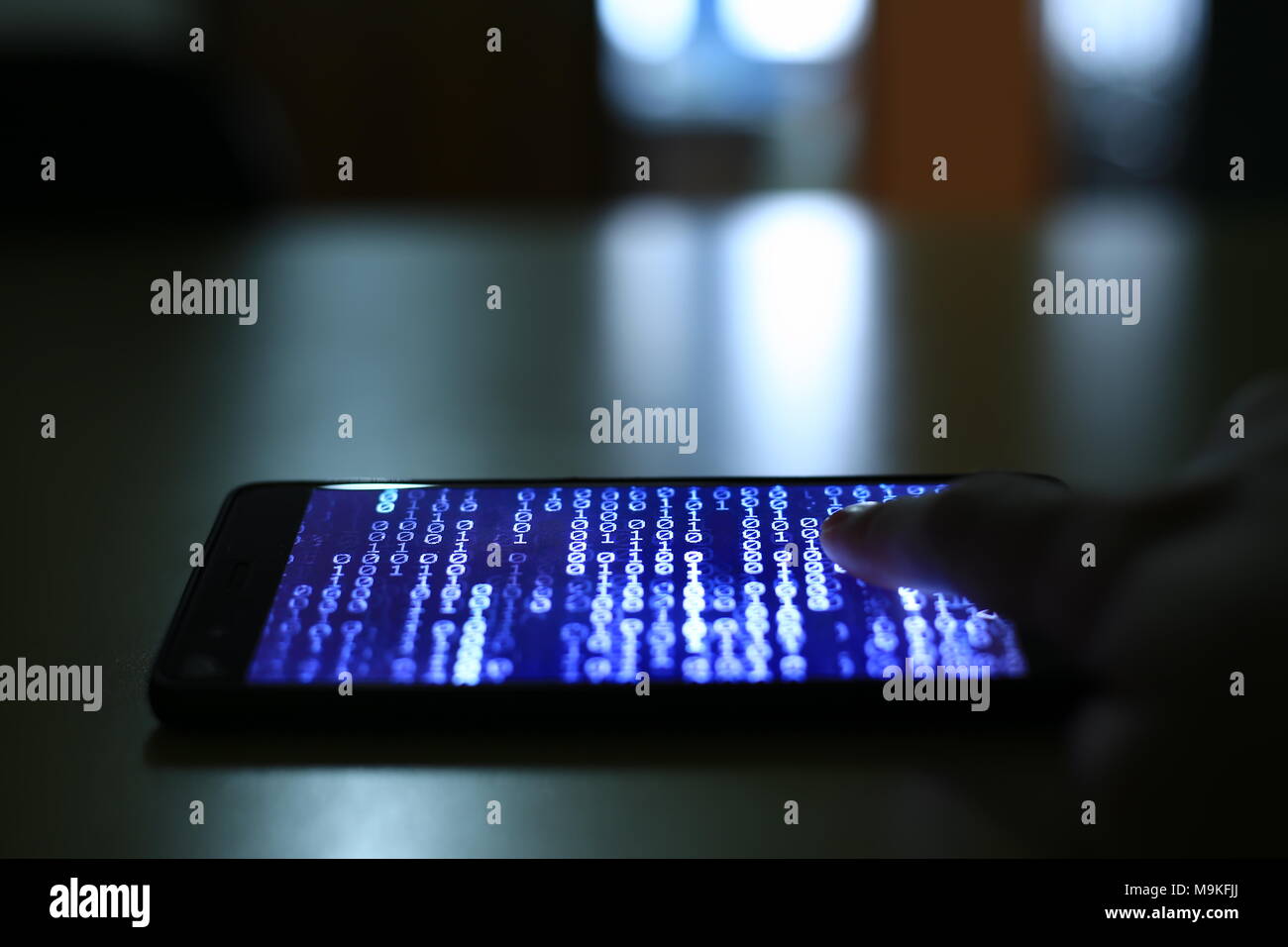 smartphone with code binary on screen. man trying to get pass lock screen. phone error and phone addiction problem concept. Stock Photo