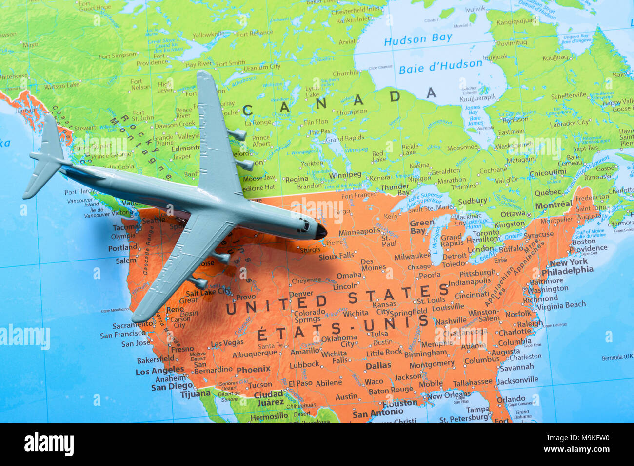 Miniature airplane on top of a - Miniature Airplane On Top Of A Map Showing Canada And United States Tourism And Travel Concept M9KFW0 