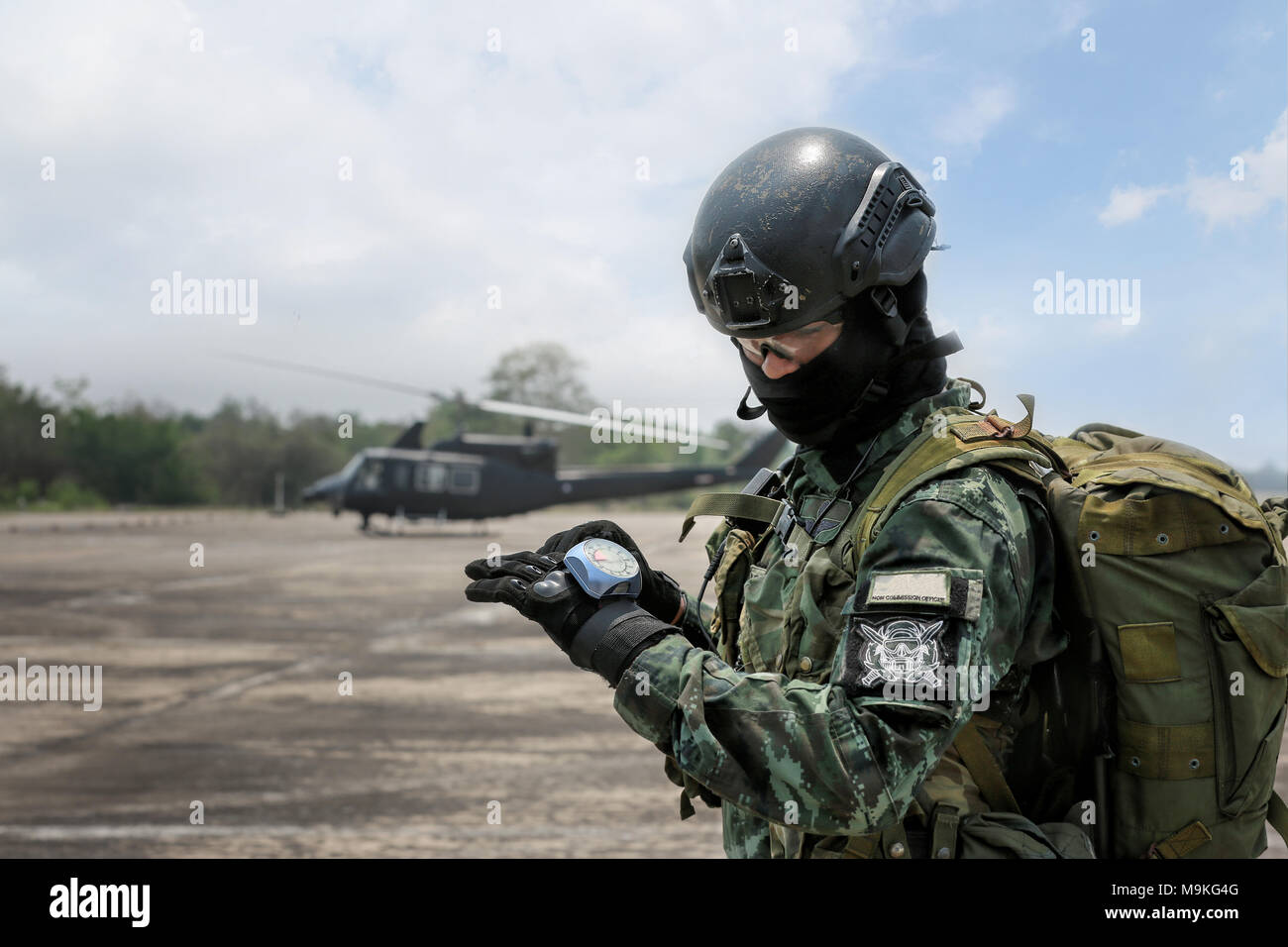 Hand in glove with the parachutist altimeter close up with helicopter background. Stock Photo
