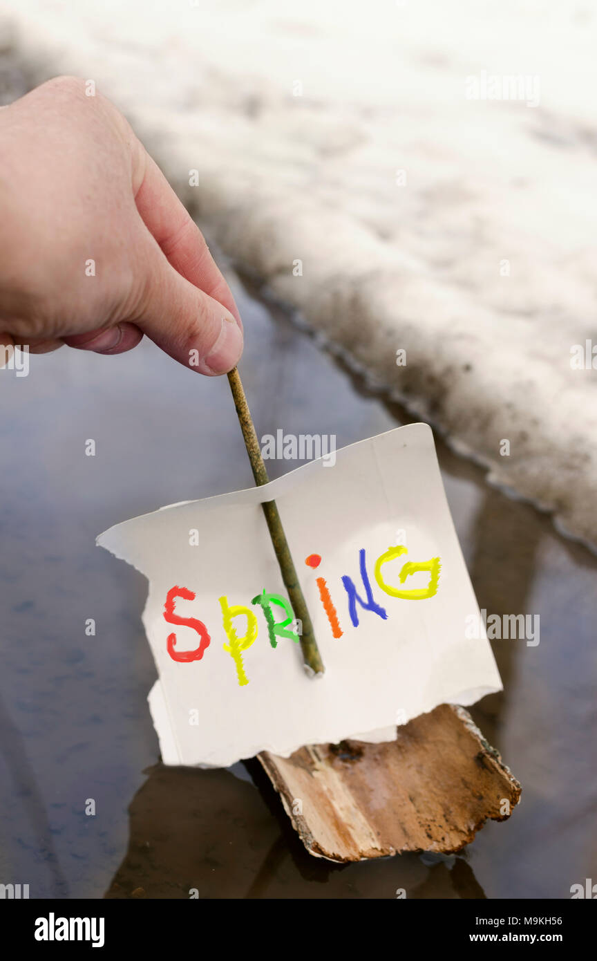 Spring Letting Male hand letting toy ship with text Spring across the sail float ...