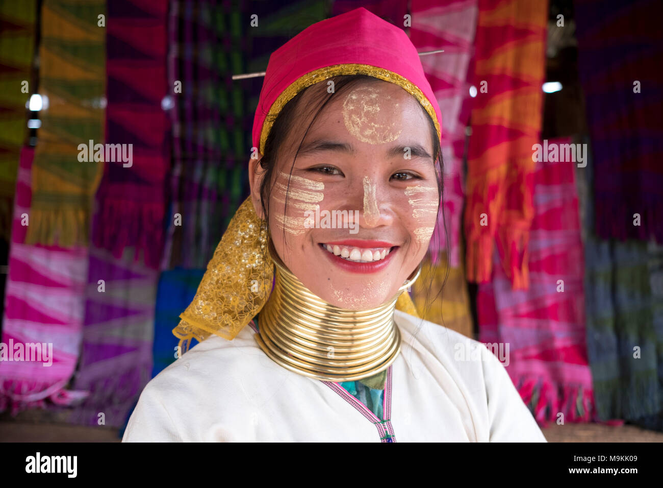 Ma Tha who is part of the Kayan tribe, waits for tourists to visit her shop. Panpet, Kayah State, Myanmar. Stock Photo
