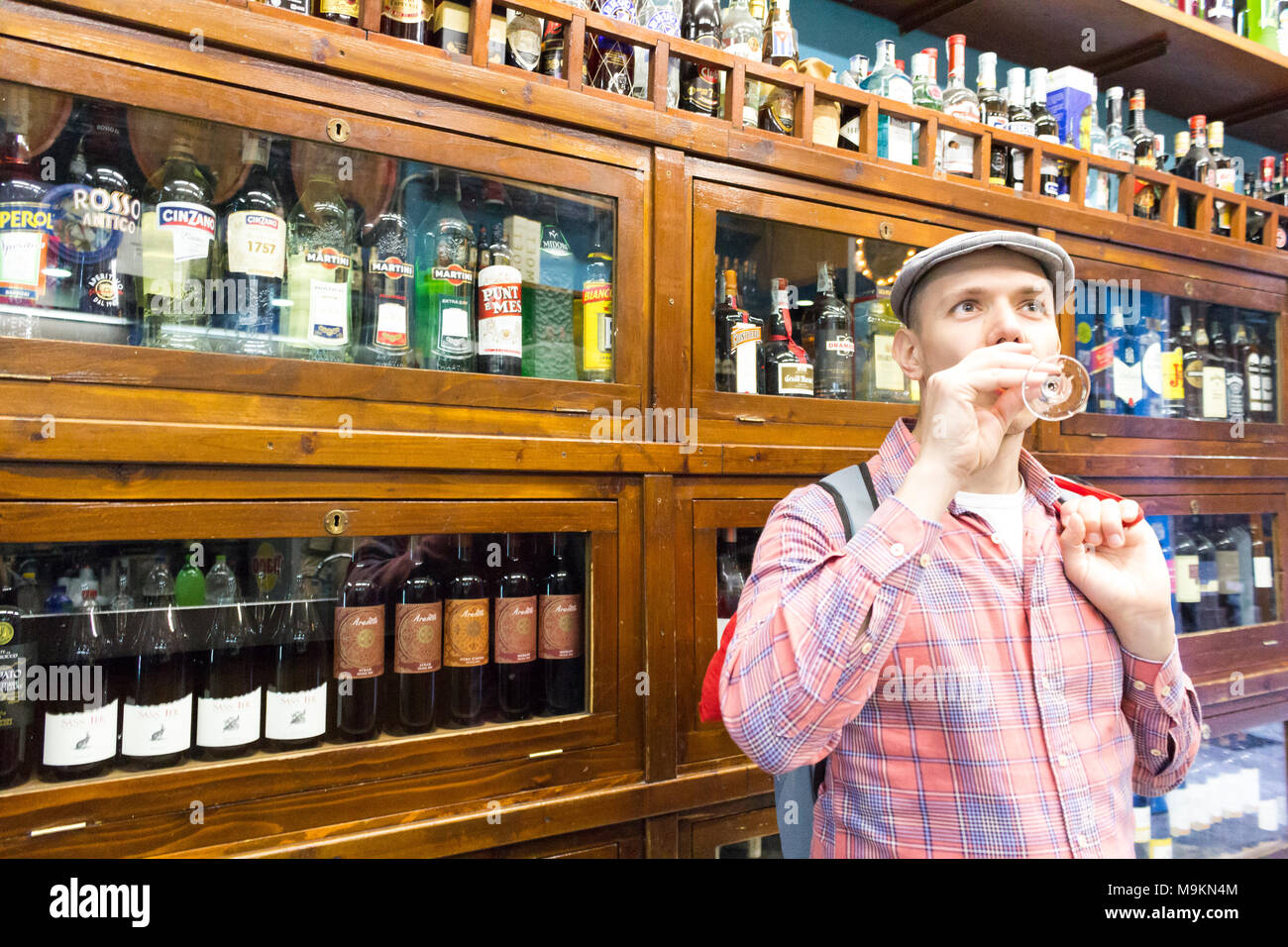 Young person savor the original taste of marsala in the blue bar. Palermo, Sicily. Italy Stock Photo