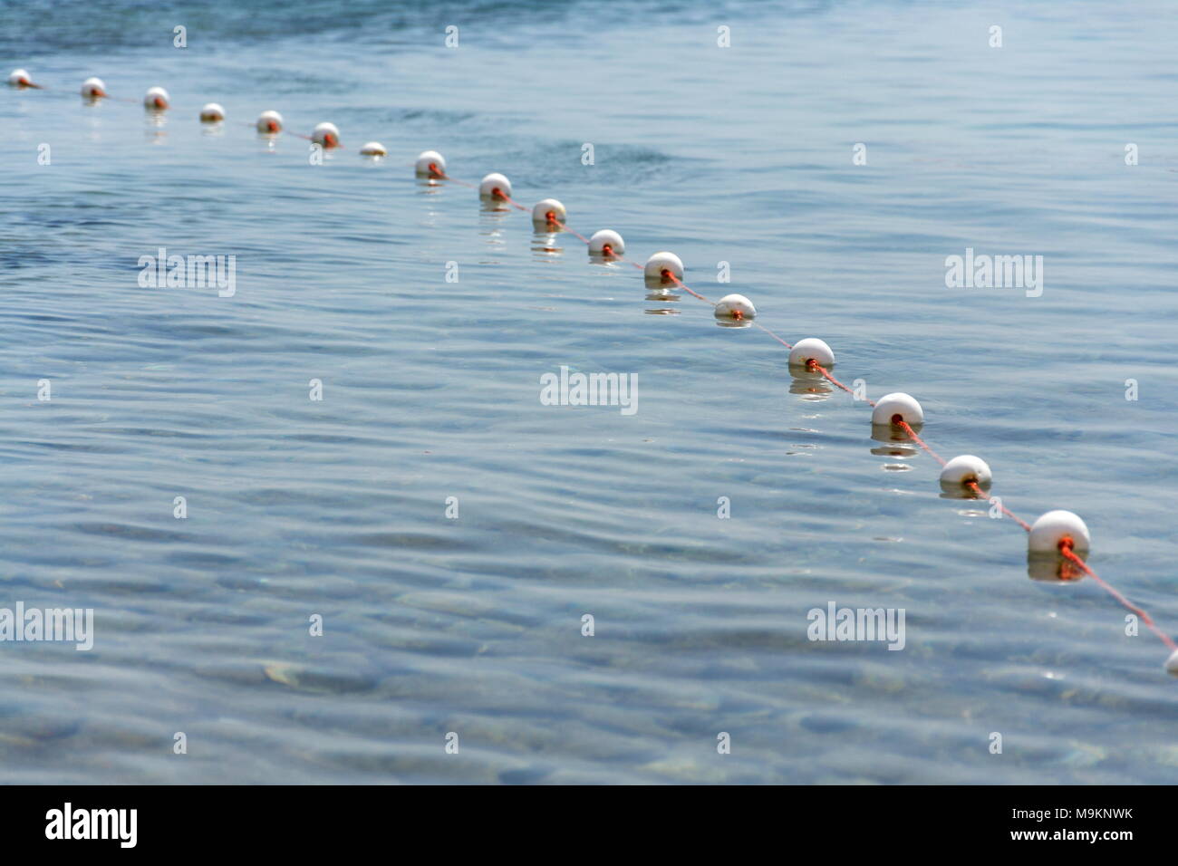 Buoys on fish net floating on surface of water Stock Photo