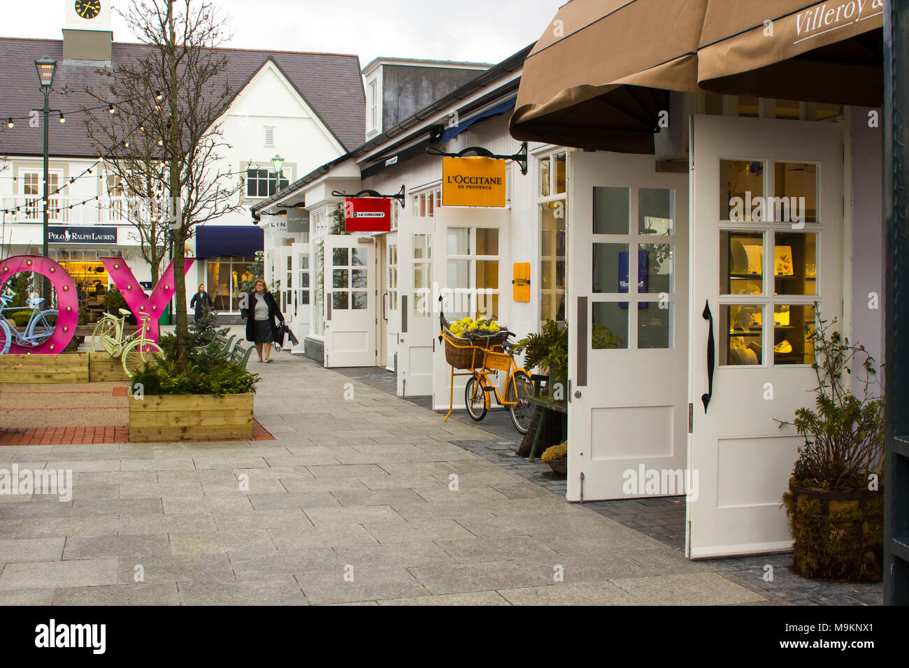 a woman laden with carrier bags while enjoying some retail therapy at the up market Kildare Village shopping outlet  in County Kildare Ireland Stock Photo