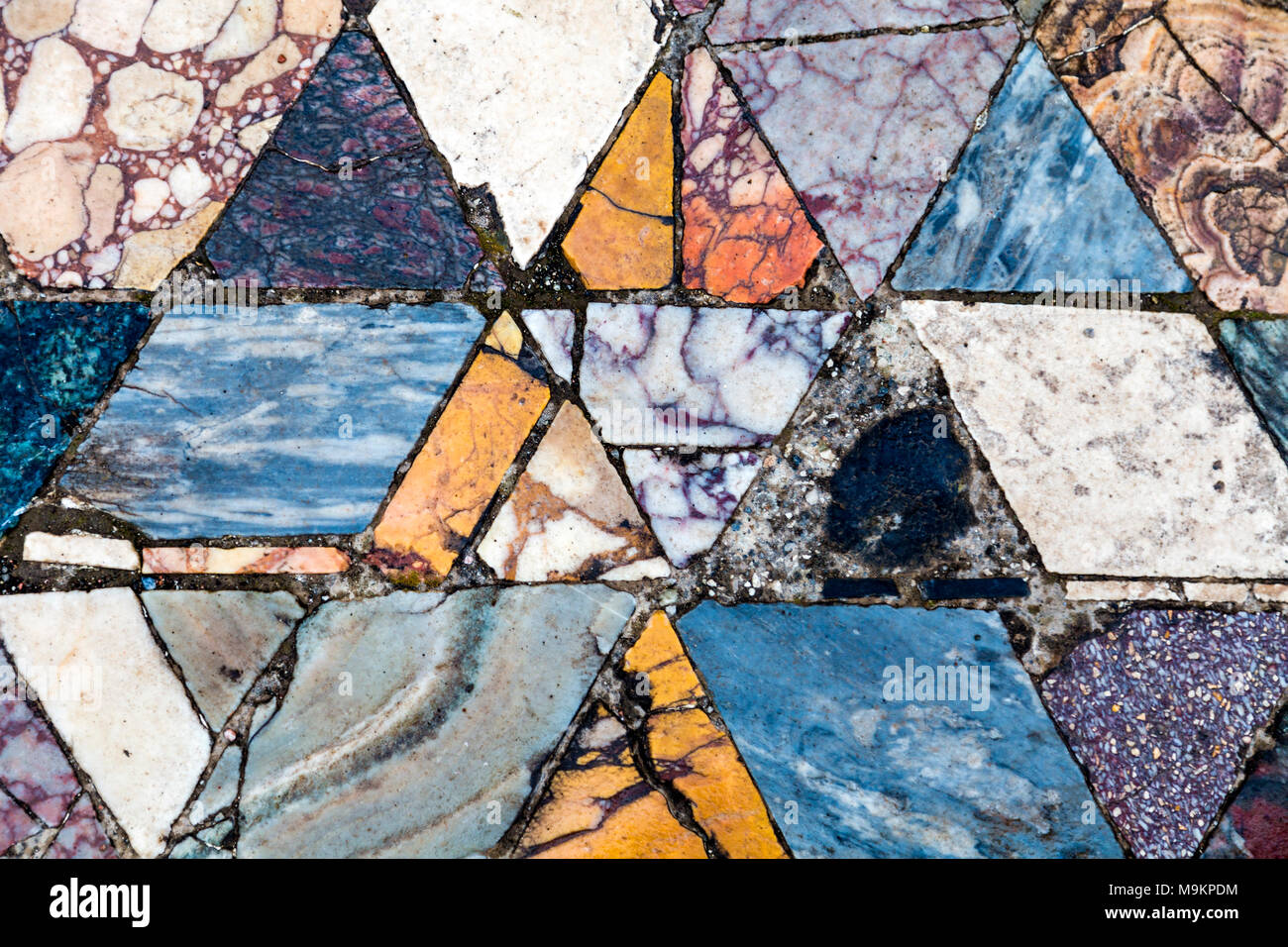 Colourful rhombic tiles of a marble mosaic floor at the ancient city of Herculaneum, Italy Stock Photo