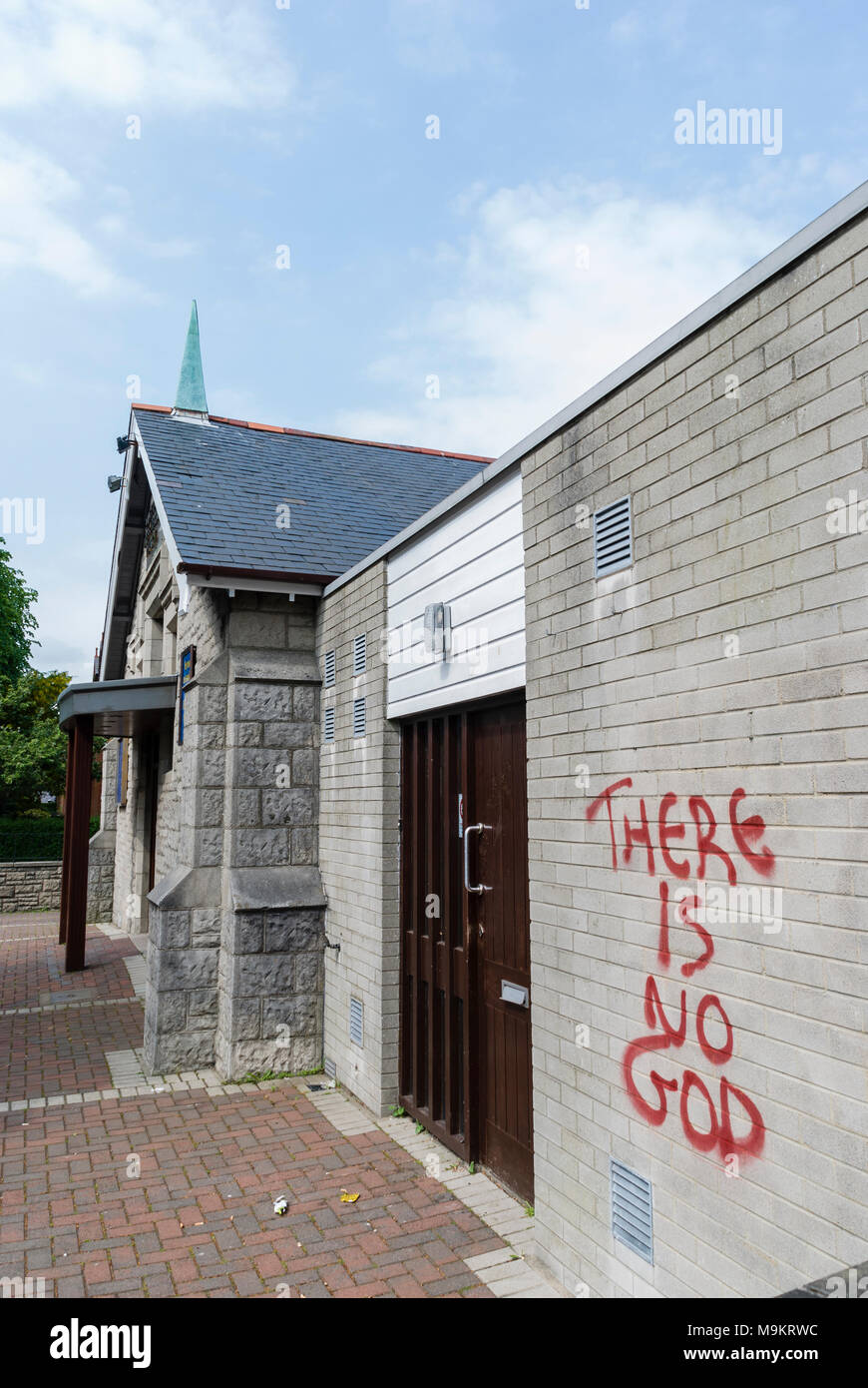 Graffiti on a wall of a church saying 'There Is No God' Stock Photo