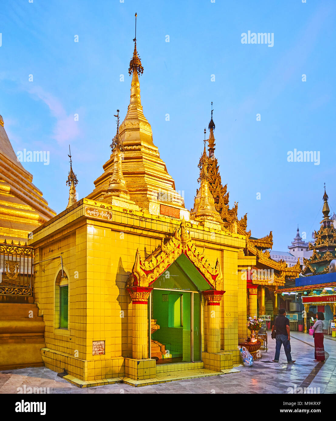 YANGON, MYANMAR - FEBRUARY 14, 2018: The main stupa of Sule Pagoda is surrounded by numerous shrines with golden images of Lord Buddha, on February 14 Stock Photo