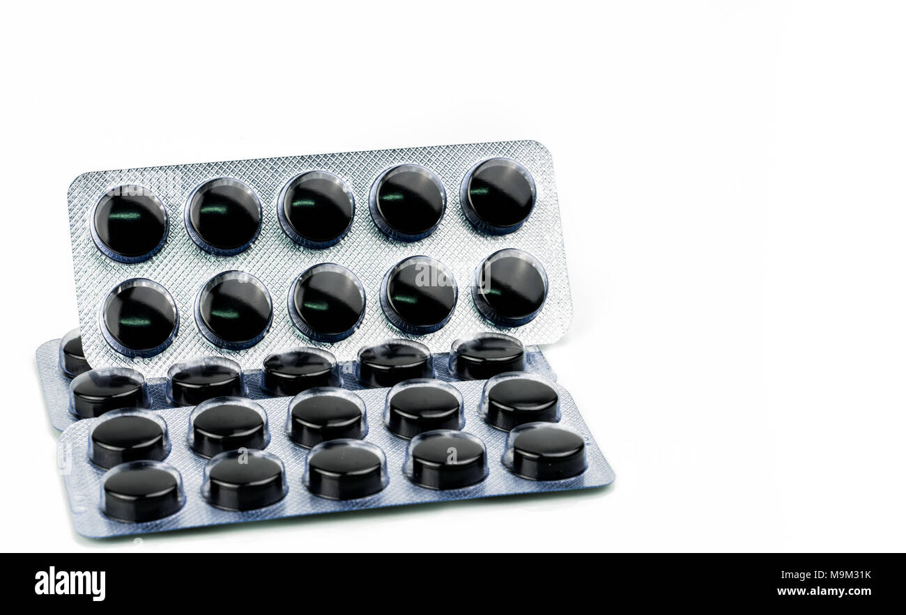 Activated charcoal tablets pills in blister pack isolated on white  background with copy space for text. Black round pills for treatment  poisoning from Stock Photo - Alamy