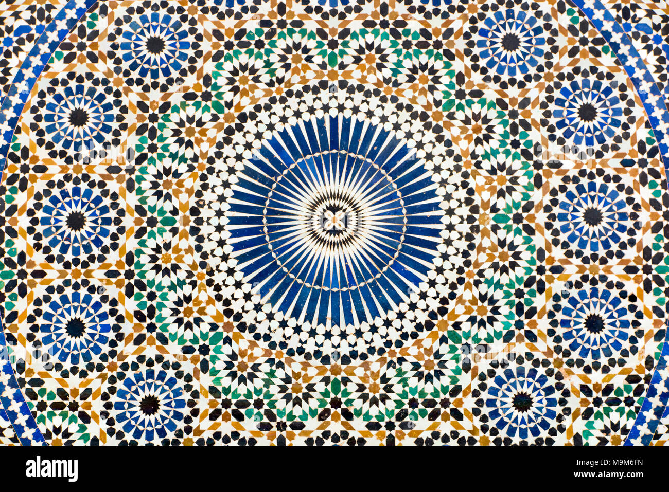 Morocco, Meknes, Place el-Hedim, colourful zellij patterned tilework decorating water fountain Stock Photo