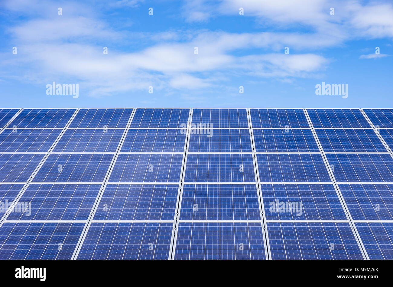 Photovoltaic cells on roofs provide alternative, renewable and solar energy. Stock Photo