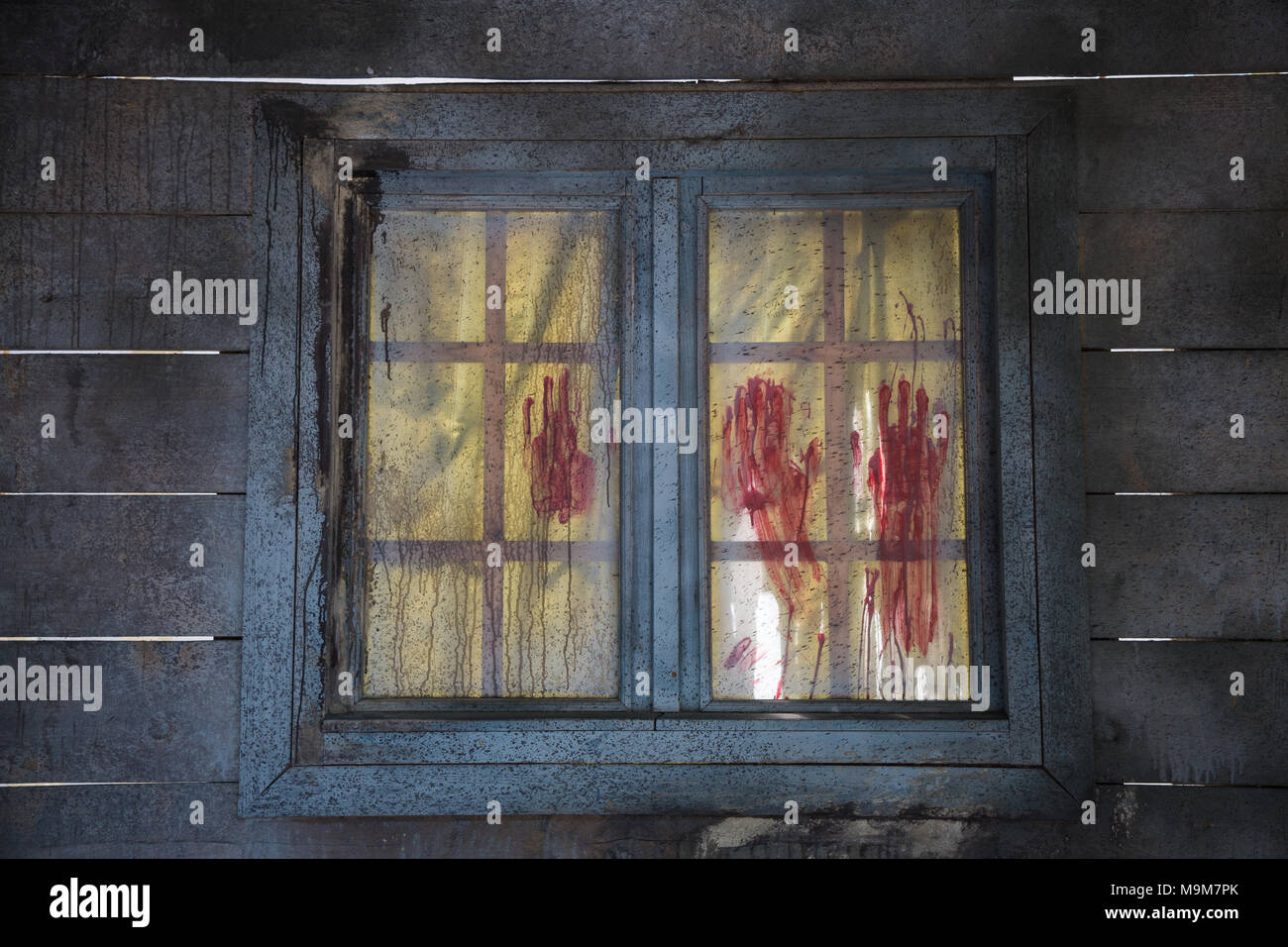 Bloodstained Red Fingerprints on Closed Wooden Window. Stock Photo