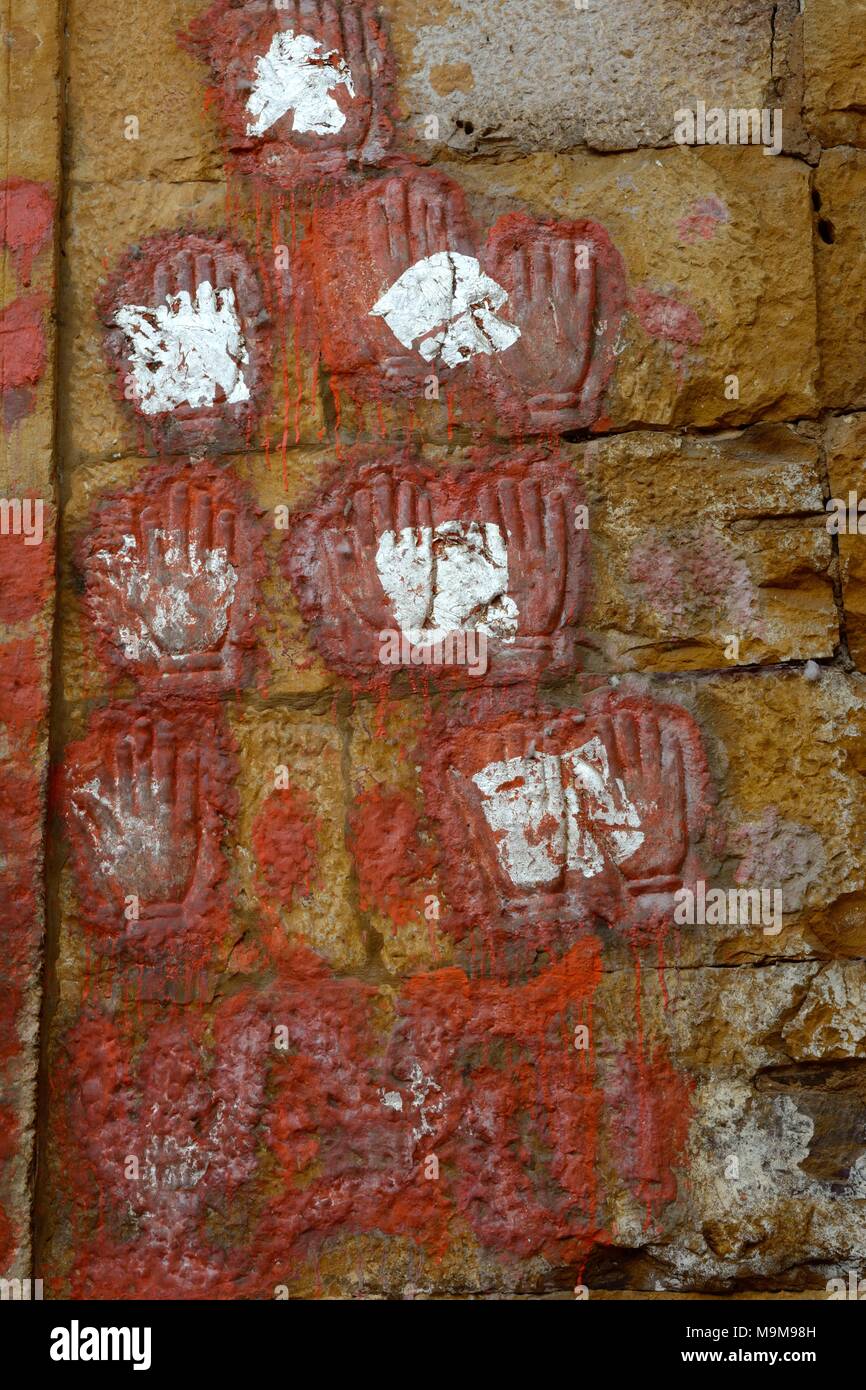 Sati hand marks of women who immolated themselves on the funeral pyre of their husbands on the wall of City palace Jaisalmer  Rajashan India Stock Photo