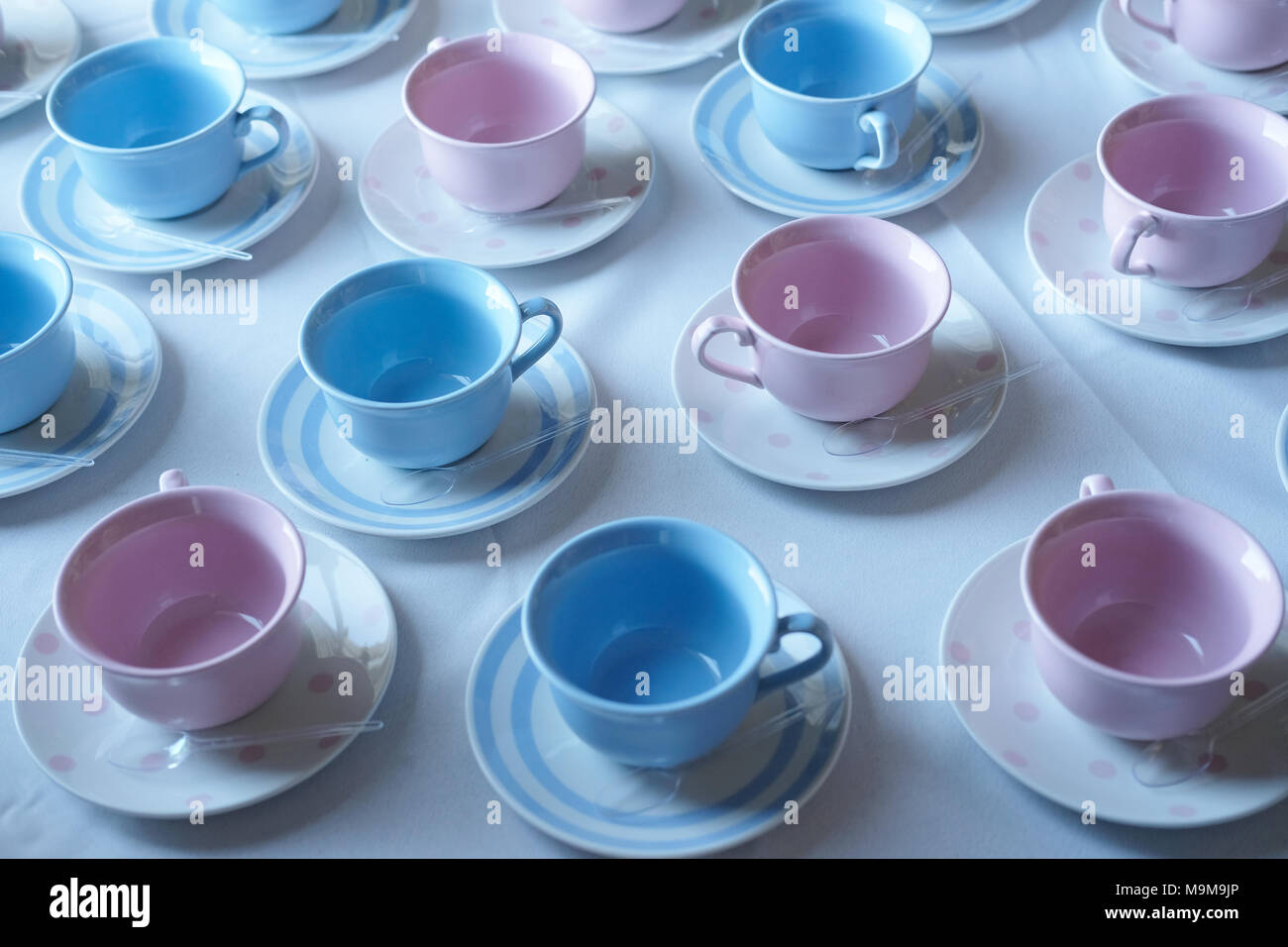 Empty pink and blue cups on a table. Stock Photo